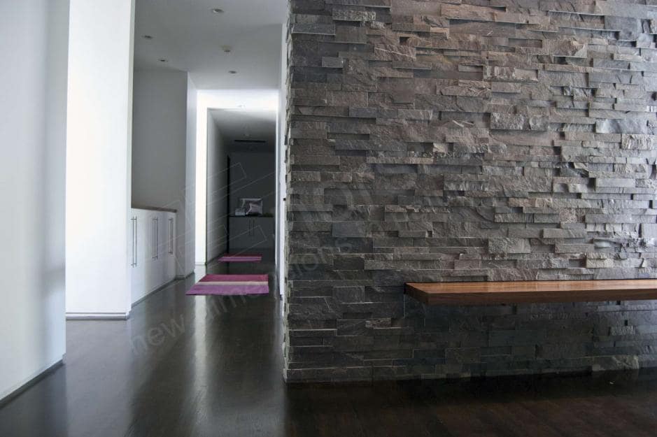 Norstone Natural Stone Veneer XL Series Charcoal Rock Panel used on a foyer wall with a built in cantilevered simple wooden bench